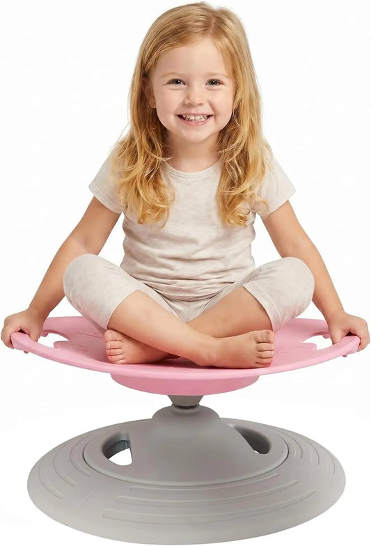 Girl sitting cross-legged on pink sensory spinning seat