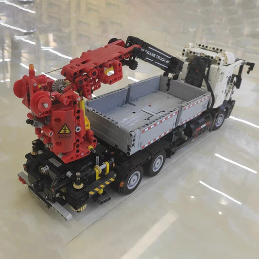 Assembled crane truck building block model, rear view with crane arm extended
