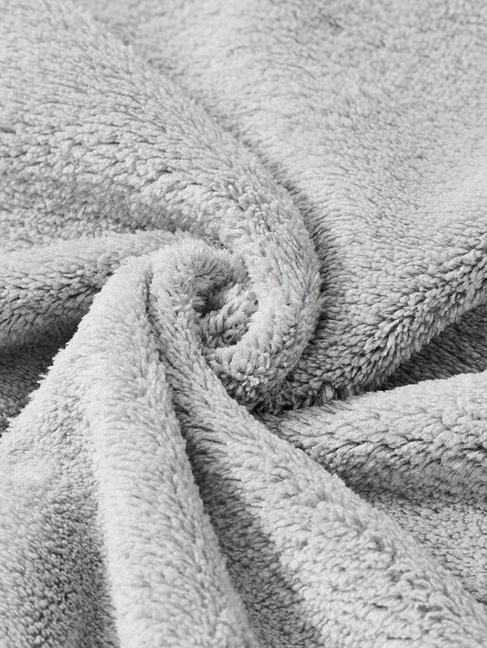 Close-up swirl texture of the grey koala hooded baby bath towel's soft terry cloth fabric