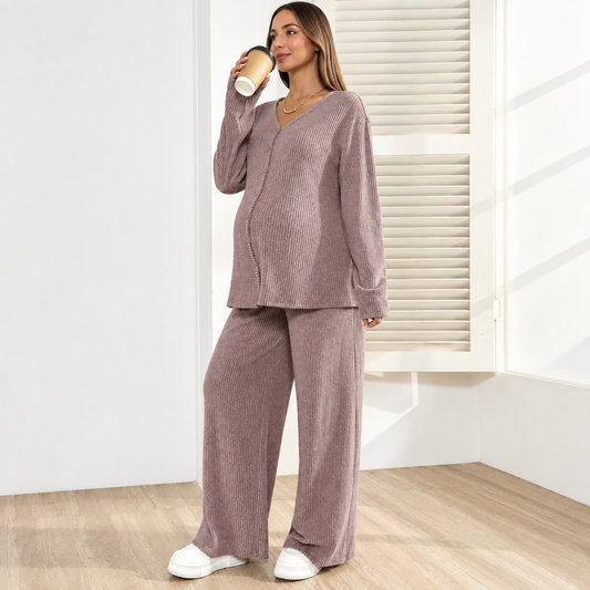 Pregnant woman wearing pink maternity V-neck vest and loose trousers two-piece set, front view