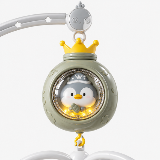 Close-up of the grey penguin crib mobile's interactive music and light module