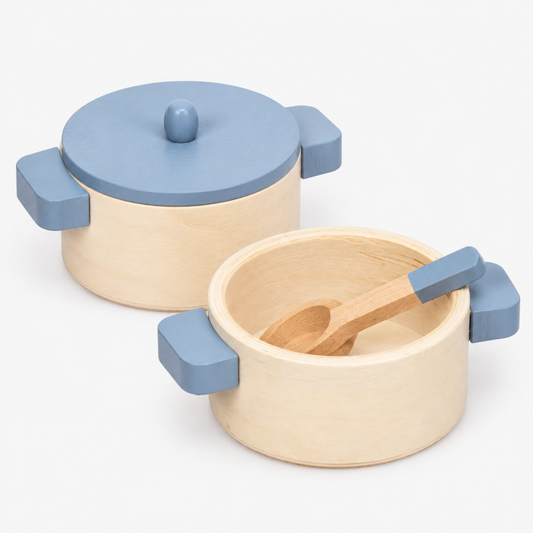 Close-up of wooden toy cooking pots with lids from the kids pretend play kitchen cookware set