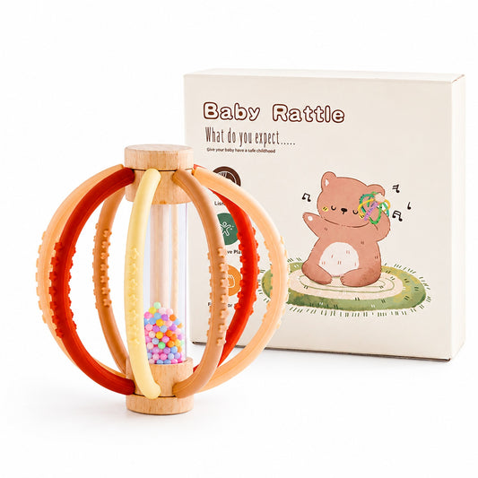 Wooden rain drum baby rattle in terracotta colourway with red, orange, peach and cream ribbed silicone teething rings, shown with retail gift box
