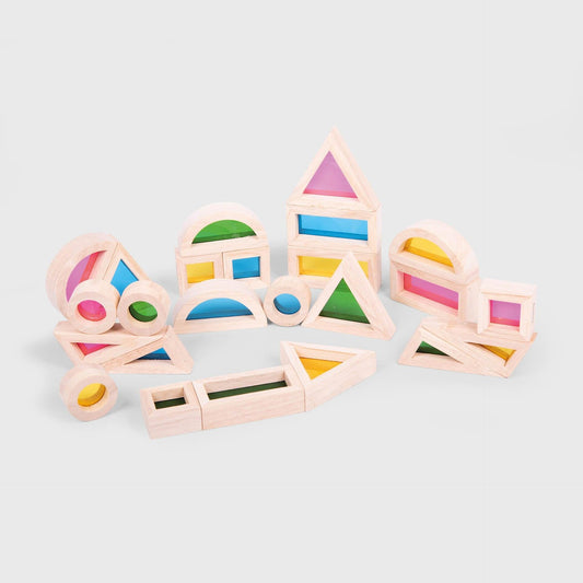 Close-up of triangular and rectangular wooden sensory blocks showing red, blue, and yellow acrylic inserts