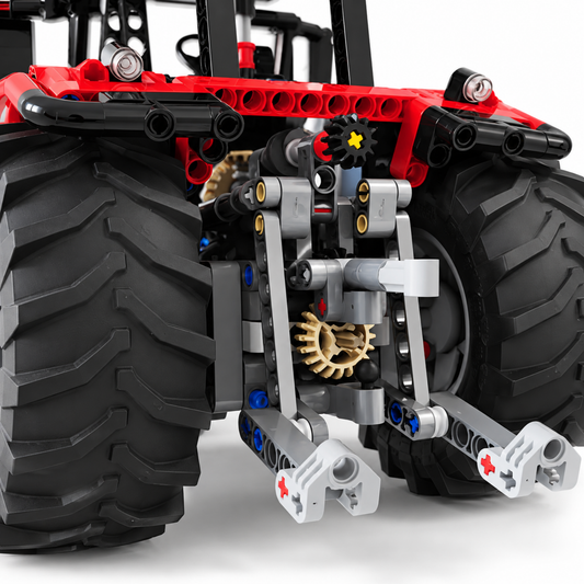 Red farm tractor technic building block model, side view showing wheels and tread
