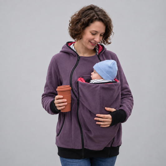 Parent wearing babywearing kangaroo hoodie with baby in front pouch
