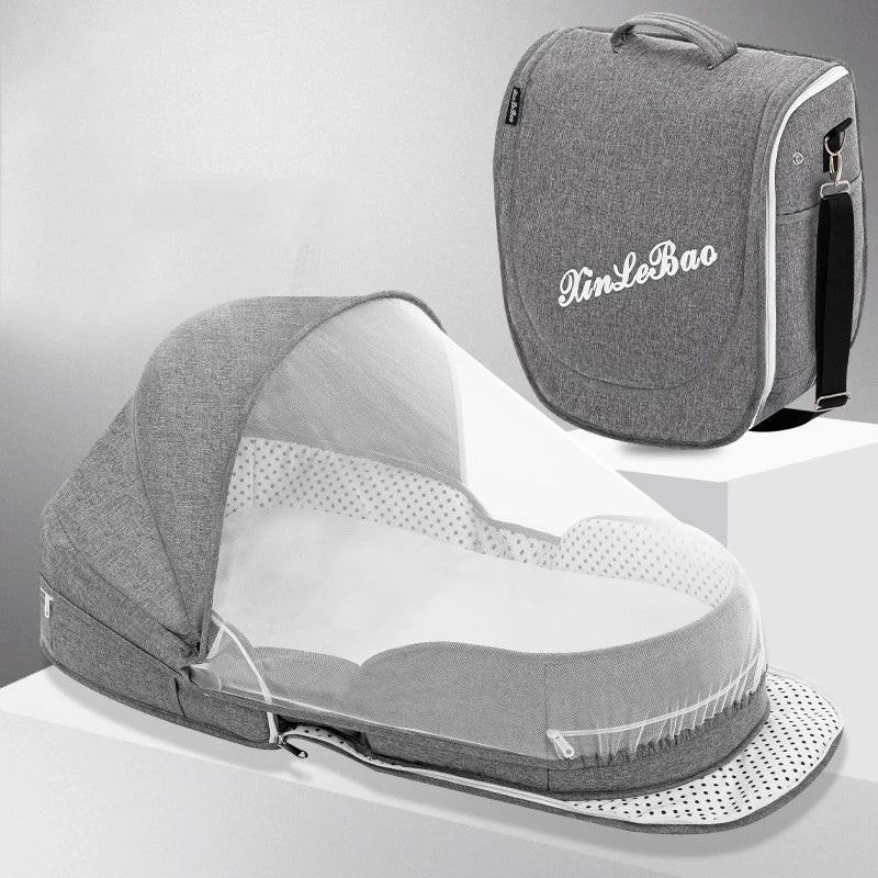 Grey baby travel bed with mosquito net