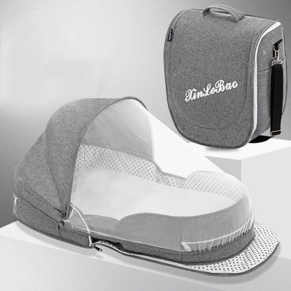 Grey baby travel bed with mosquito net