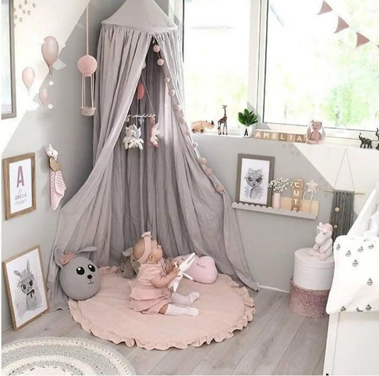 Pink round ruffled baby play mat in nursery