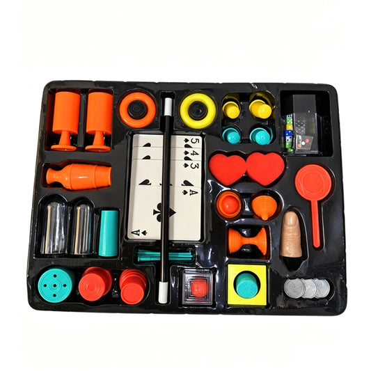 Magic trick set props laid out - cards, cups, rings, coins, wand