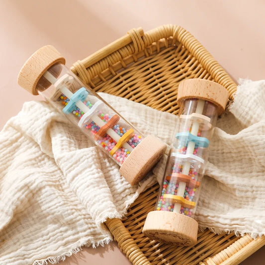 Two wooden rainstick rattles on woven basket with cloth