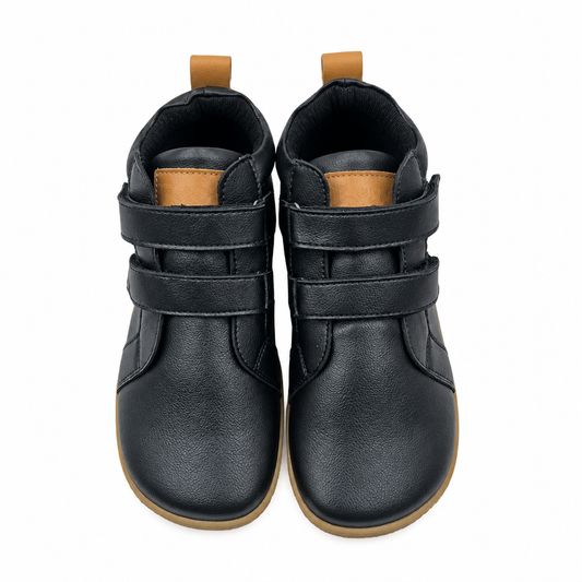 Black leather barefoot ankle boot for toddlers, studio product photo