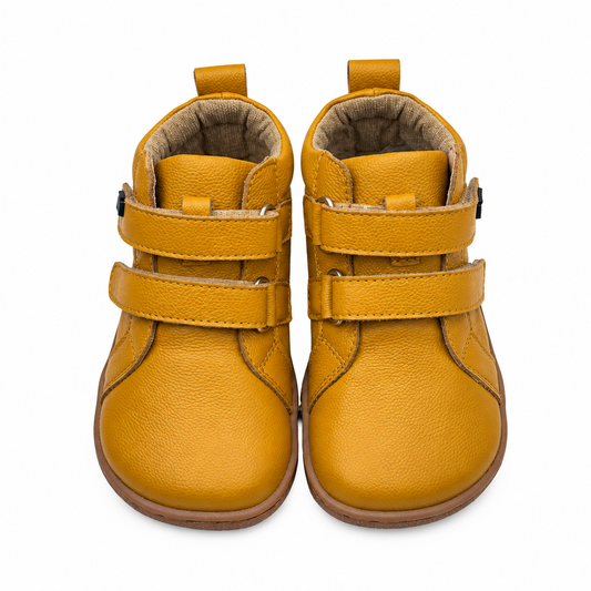 Yellow barefoot ankle boot for toddlers, studio product photo