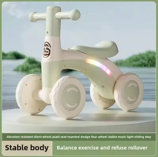 Green baby balance bike — studio shot