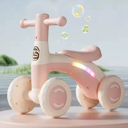 Pink baby balance bike with music bubbles