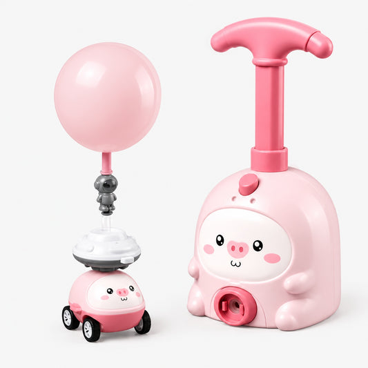 Pink piggy-design balloon-powered car toy with launcher and balloon, studio shot