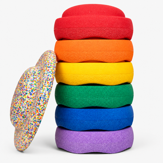 Rainbow Confetti Stacking Stones set, six balance stones stacked in rainbow colors with a speckled confetti stone leaning against the base
