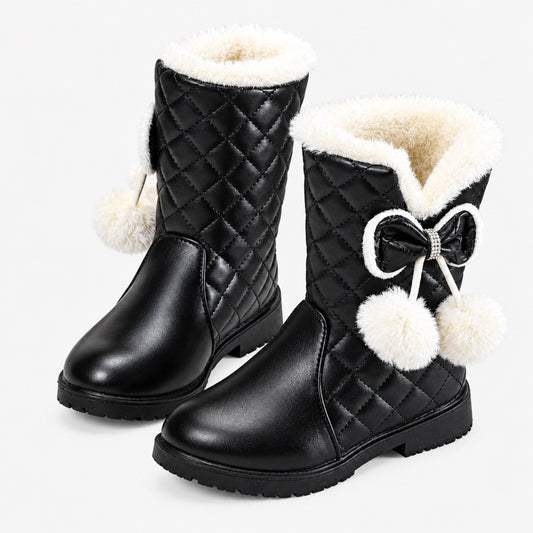 Black quilted girls' snow boots with faux fur cuff, bow and pom-poms, studio product shot on white background