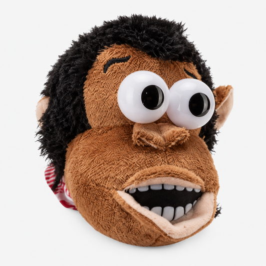 Close-up of the magnetic feeding gorilla plush toy's face showing its expressive 3D eyes and soft brown fur, studio shot