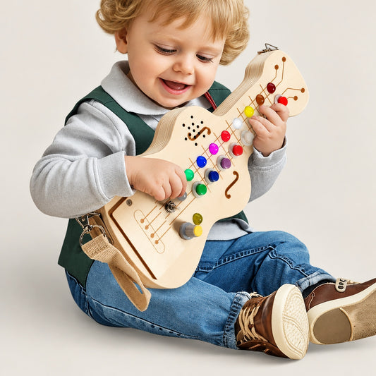 Toddler playing with the wooden kids toy guitar with light-up buttons
