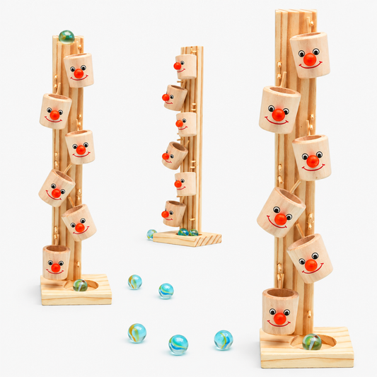 Wooden marble run tree block toy with three towers and loose wooden marble balls on a plain white studio background
