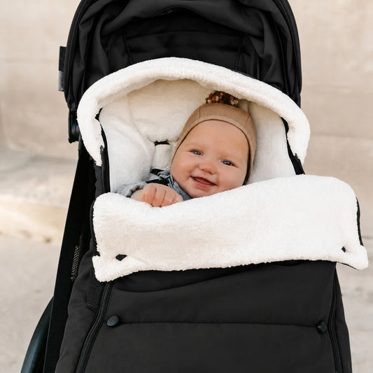Polyester and nylon stroller footmuff in Black, fitted on a stroller
