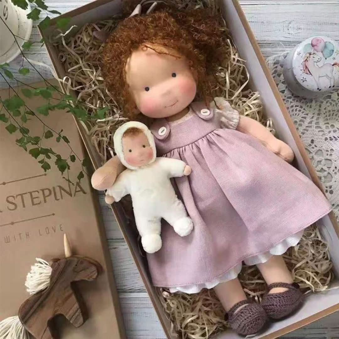 Handmade fabric doll in purple dress