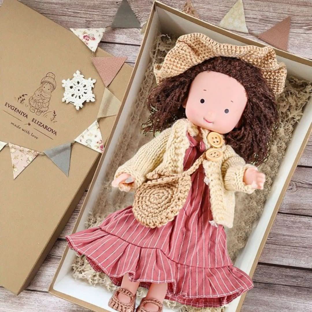 Handmade fabric doll in red dress